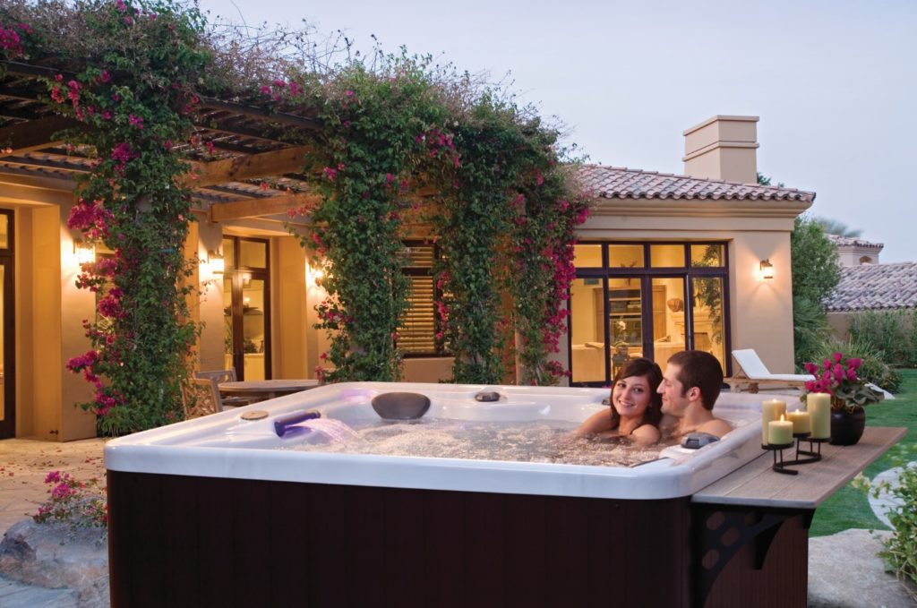 A Marquis spa is tastefully decorated using our hot tub landscaping tips.
