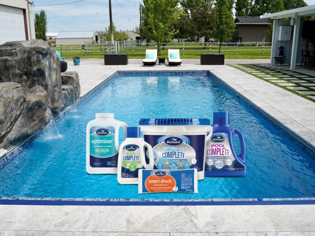 An in-ground pool in a backyard with an overlay of pool chemical shown over the water.